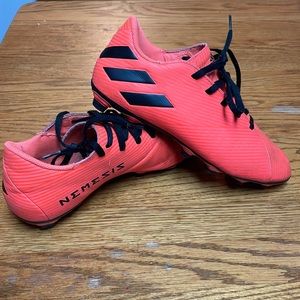 Orange and black adidas nemesis soccer cleats